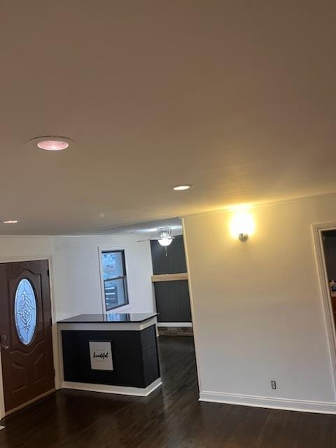 kitchen featuring ceiling fan, dark hardwood / wood-style flooring, and crown molding