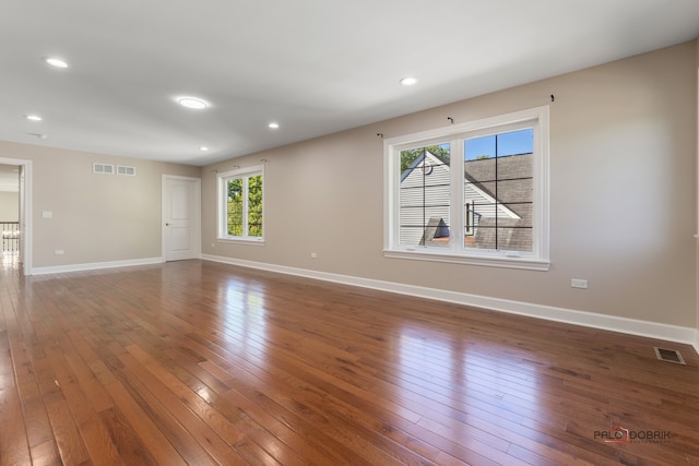 spare room with hardwood / wood-style flooring