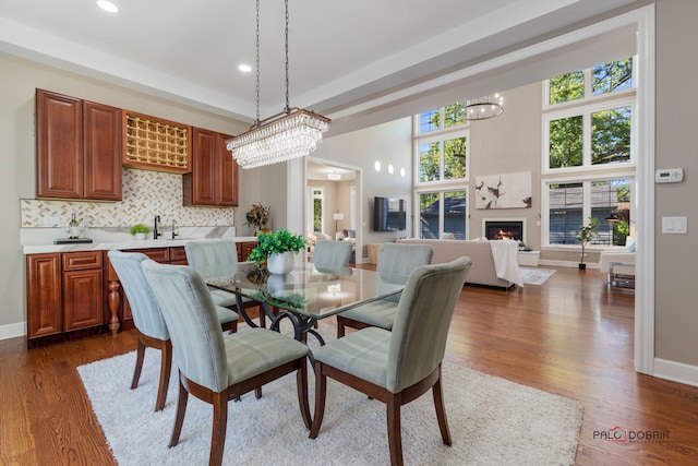 dining space featuring dark wood-type flooring and a notable chandelier