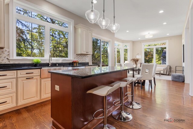 living room featuring a chandelier, hardwood / wood-style floors, and a towering ceiling