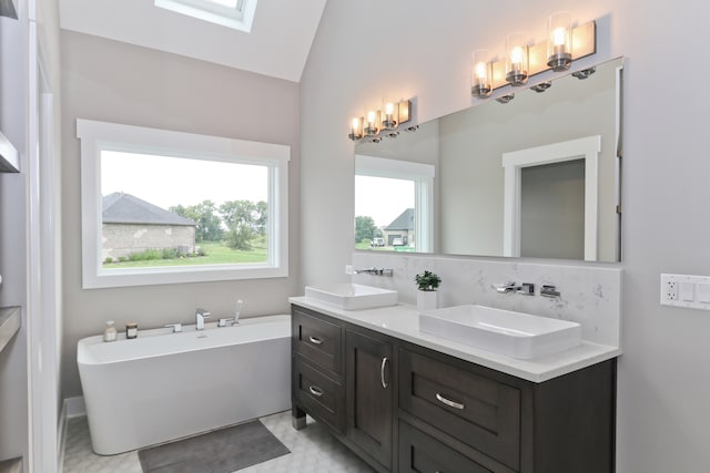 bathroom with vanity, a tub to relax in, tasteful backsplash, and vaulted ceiling