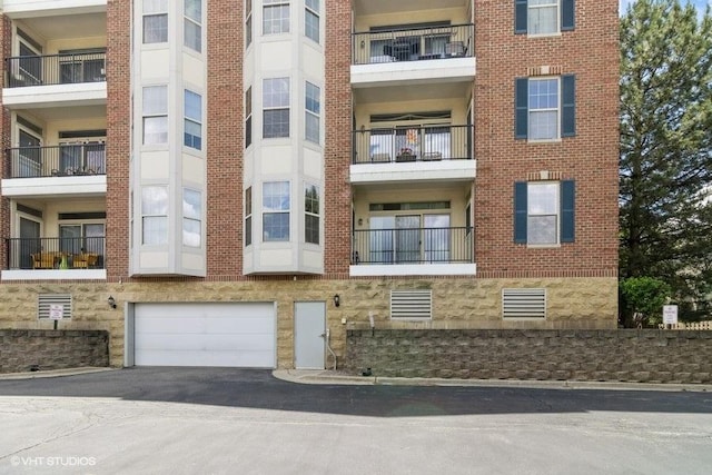 3135 Town Square Dr Unit 106, Rolling Meadows, IL 60008 - view of apartment building / complex with an attached garage and asphalt driveway
