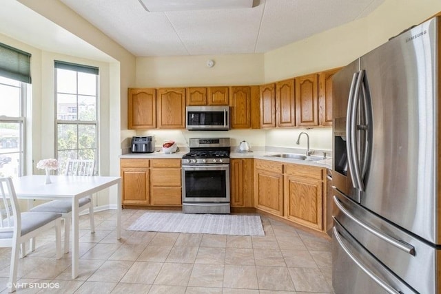 3135 Town Square Dr Unit 106, Rolling Meadows, IL 60008 - kitchen with stainless steel appliances, light countertops, light tile patterned flooring, and brown cabinets