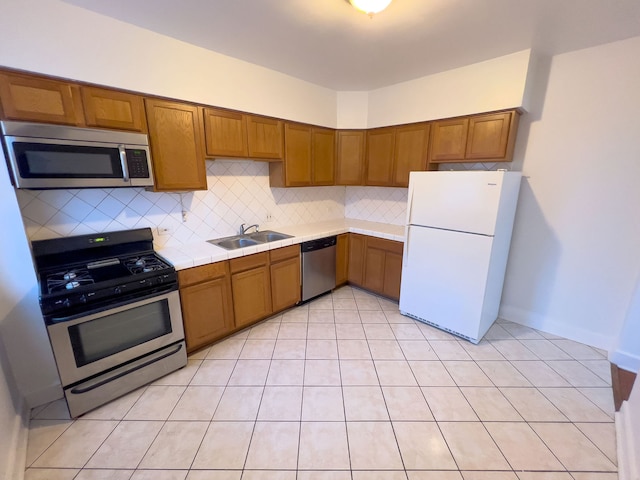 kitchen featuring stainless steel appliances, sink, and tasteful backsplash