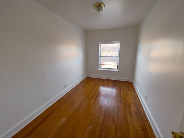 empty room with hardwood / wood-style flooring