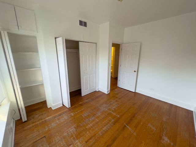 unfurnished bedroom featuring hardwood / wood-style floors