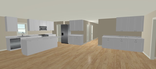 kitchen featuring sink, white cabinets, light stone counters, light hardwood / wood-style floors, and stainless steel appliances