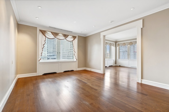 unfurnished room with wood-type flooring, ornamental molding, and plenty of natural light