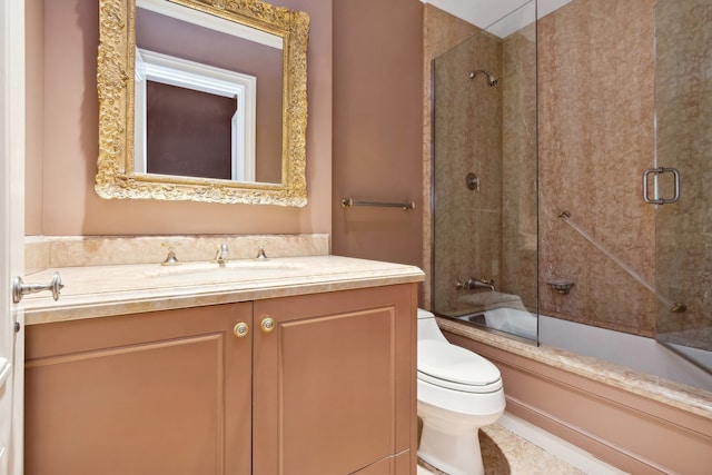 full bathroom with toilet, vanity, and bath / shower combo with glass door