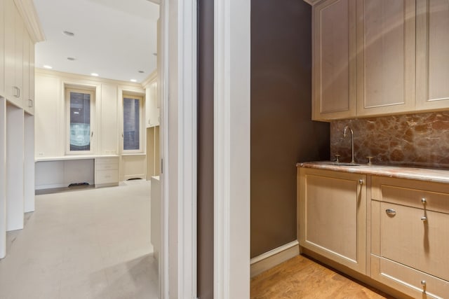 interior space featuring sink, light hardwood / wood-style floors, and crown molding