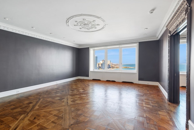 empty room featuring parquet floors and crown molding