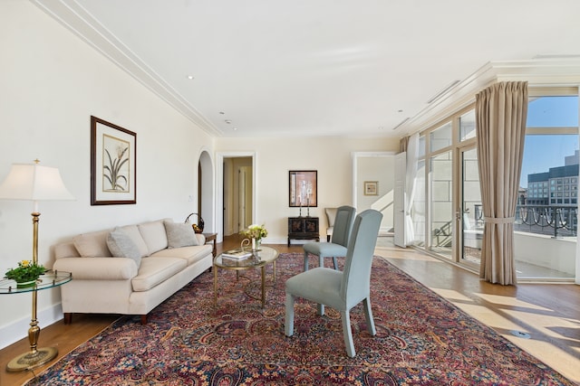 living room featuring hardwood / wood-style flooring and crown molding