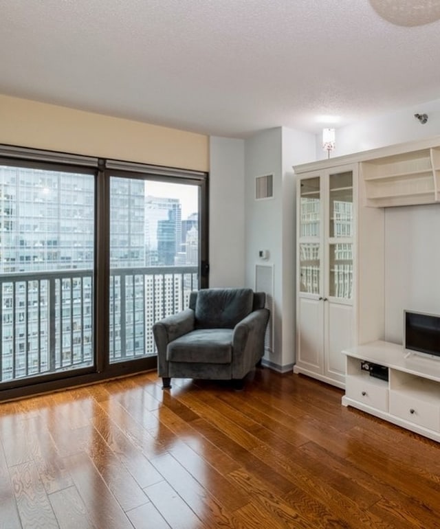 sitting room featuring dark hardwood / wood-style flooring and a textured ceiling