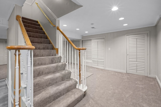 stairs with ornamental molding and carpet floors