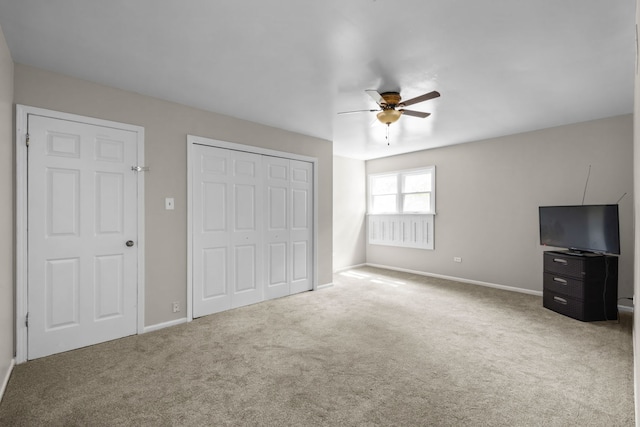 unfurnished bedroom featuring carpet and ceiling fan