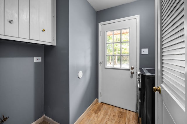 entryway featuring independent washer and dryer and light hardwood / wood-style floors