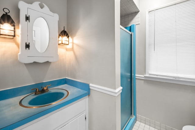 bathroom with vanity, tile patterned floors, and a shower with door