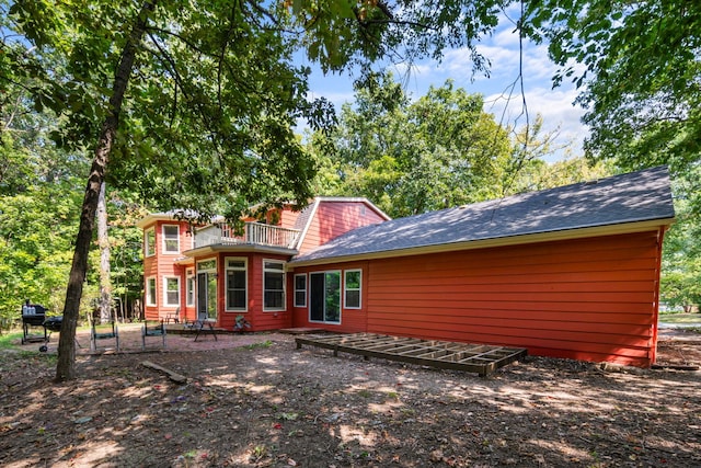 back of property with a balcony