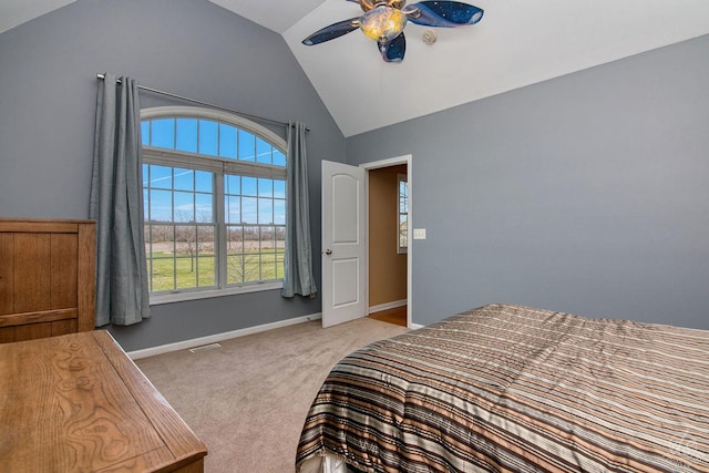 bedroom with light colored carpet, ceiling fan, and lofted ceiling