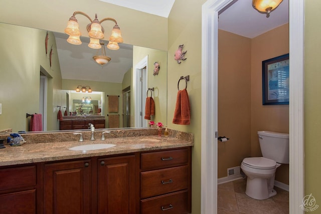 bathroom with tile patterned floors, vanity, and toilet