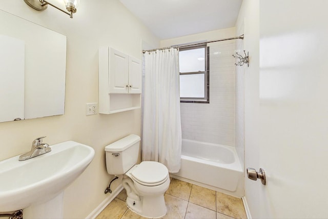 full bathroom with shower / bath combo with shower curtain, tile patterned floors, toilet, and sink