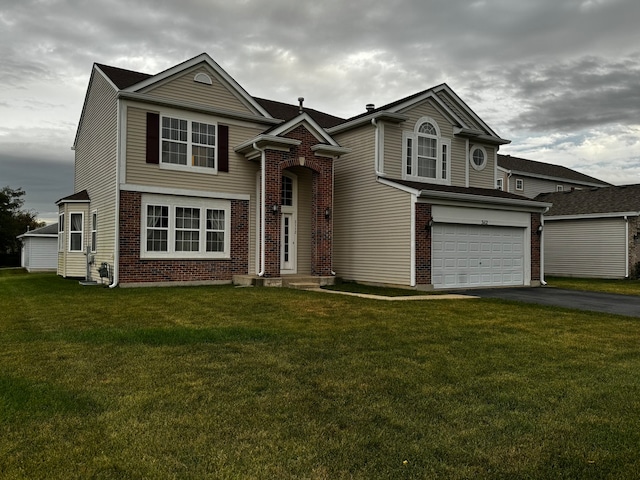 view of front of house featuring a garage and a front lawn