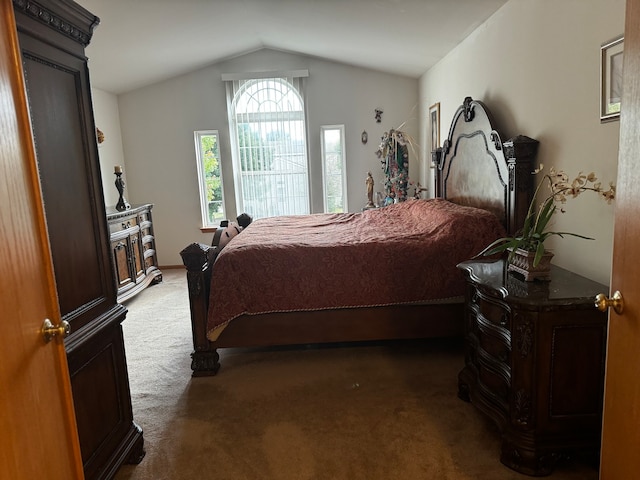 bedroom with vaulted ceiling and dark carpet