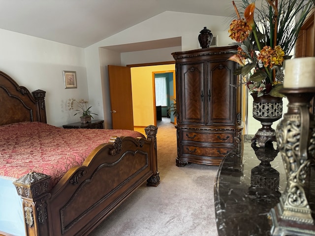 carpeted bedroom with lofted ceiling