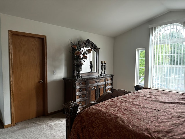 carpeted bedroom with lofted ceiling