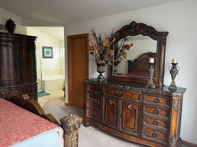 carpeted bedroom with ensuite bath