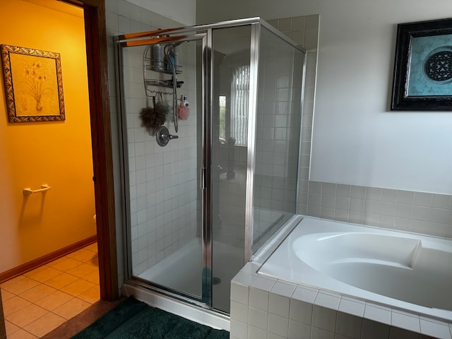 bathroom featuring tile patterned floors and shower with separate bathtub