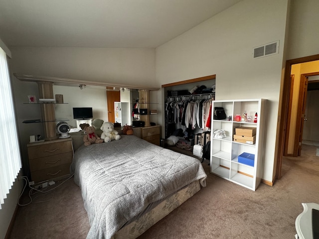 bedroom with high vaulted ceiling, a closet, and carpet flooring