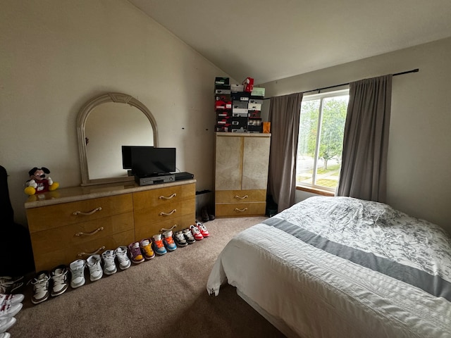 bedroom featuring lofted ceiling and light carpet