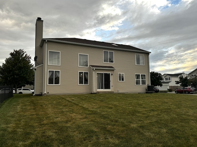 rear view of house with a yard