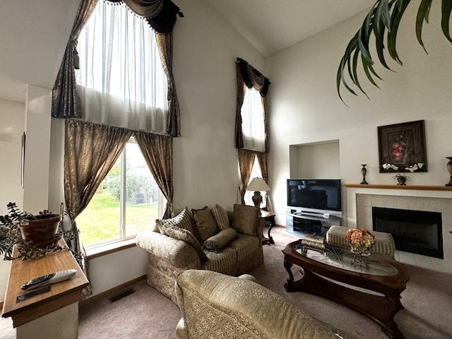 living room featuring a fireplace, carpet flooring, and high vaulted ceiling