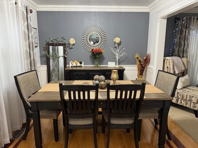 dining area featuring crown molding and wood-type flooring