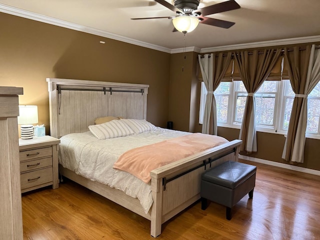 bedroom with ceiling fan, ornamental molding, and light hardwood / wood-style flooring