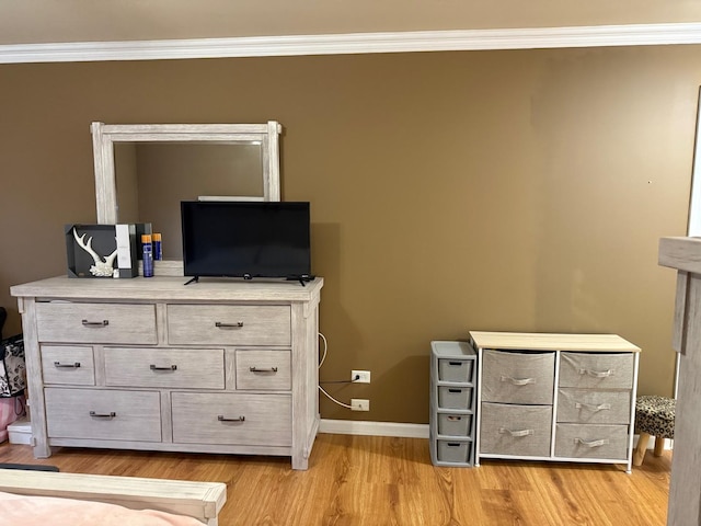 unfurnished bedroom featuring light hardwood / wood-style flooring and ornamental molding