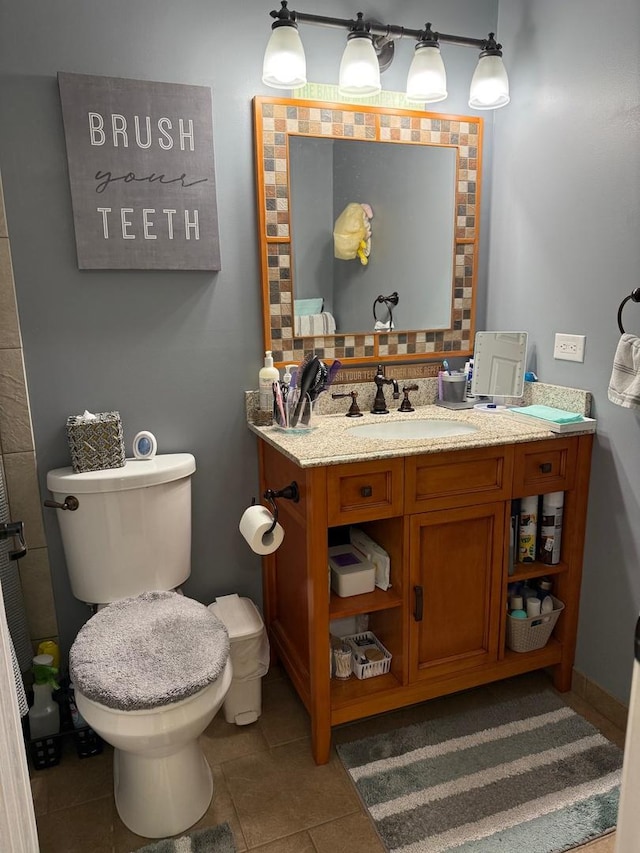 bathroom featuring tile patterned flooring, vanity, backsplash, and toilet