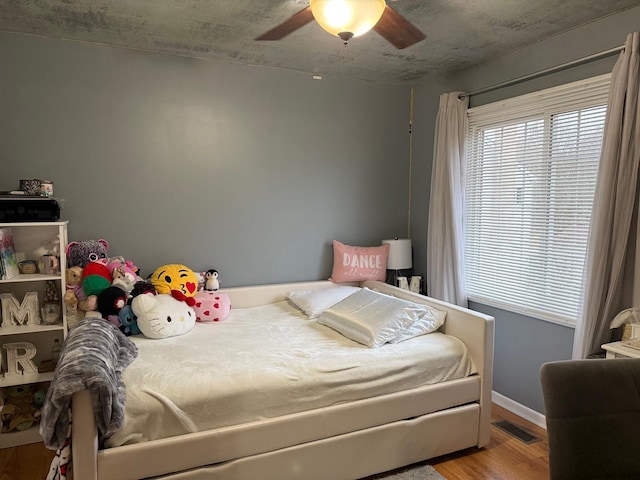 bedroom featuring hardwood / wood-style floors and ceiling fan