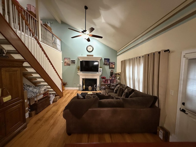 living room with ceiling fan, light hardwood / wood-style flooring, and lofted ceiling