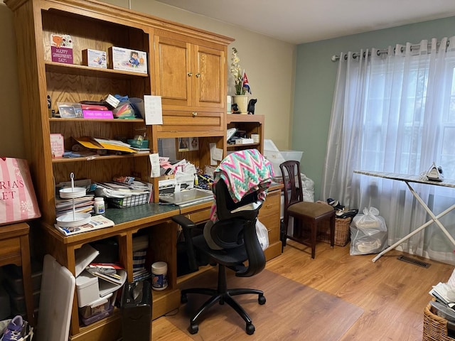 office with light hardwood / wood-style flooring