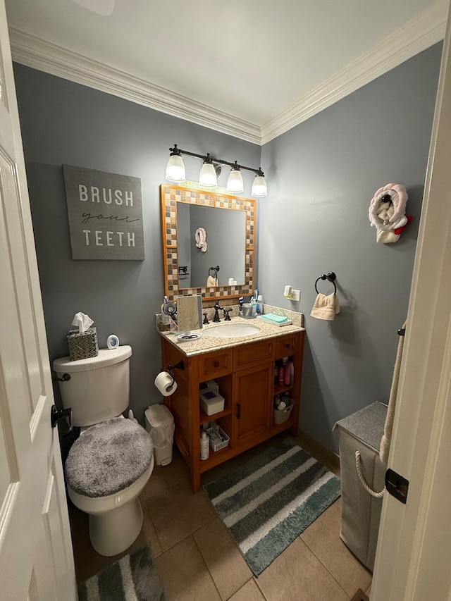 bathroom with tile patterned flooring, vanity, toilet, and ornamental molding