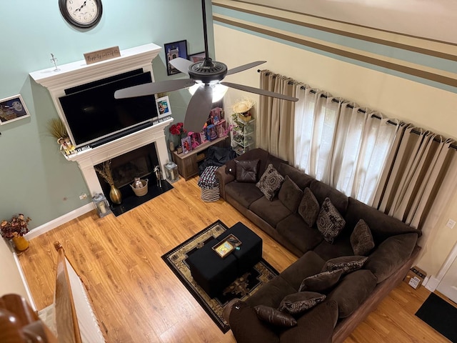 living room with ceiling fan, wood-type flooring, and vaulted ceiling