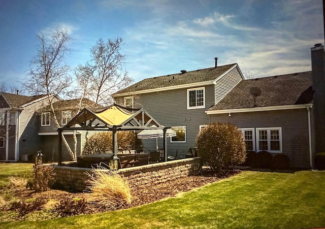 rear view of house with a lawn