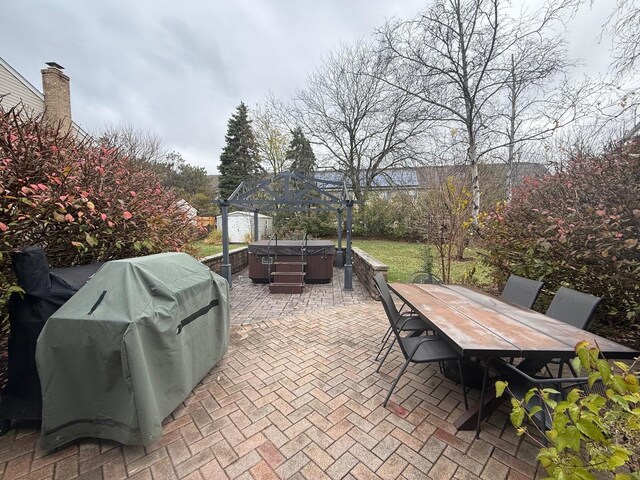 view of patio with a grill and a hot tub