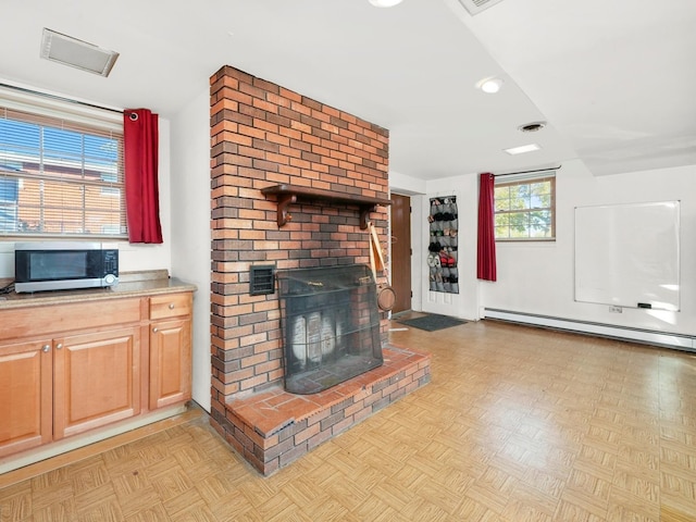 unfurnished living room featuring a brick fireplace, a baseboard radiator, and light parquet floors