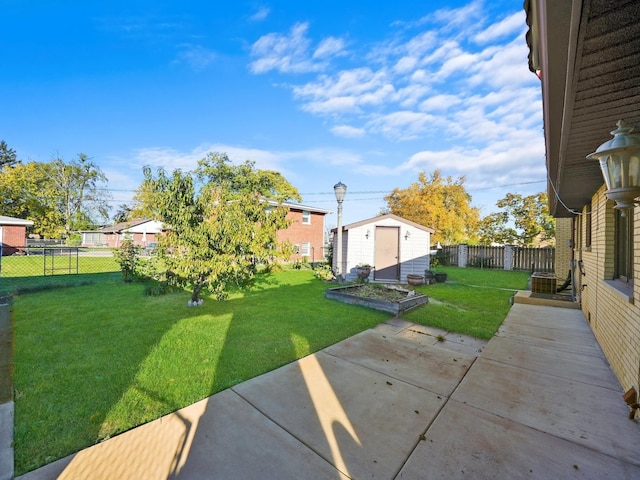 view of yard featuring a storage unit and a patio area