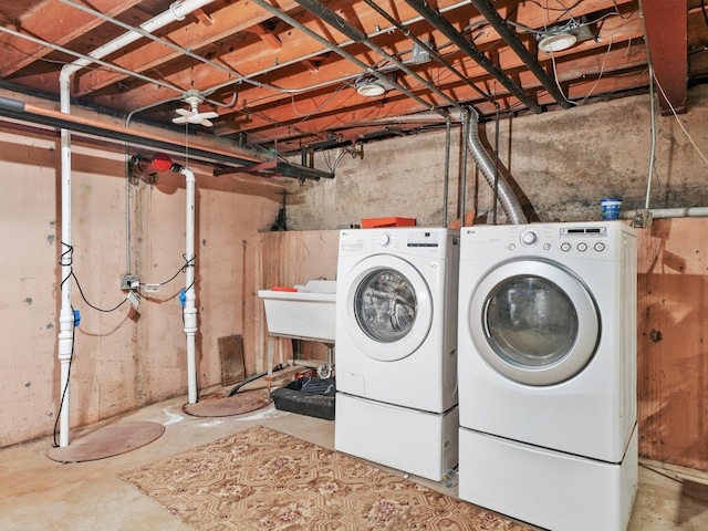 clothes washing area with washer and clothes dryer