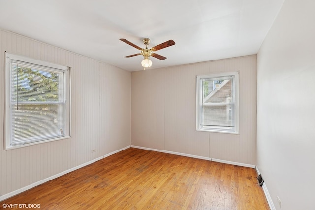 1242 E 98th St, Chicago, IL 60628 - empty room with light wood-style floors, ceiling fan, and baseboards